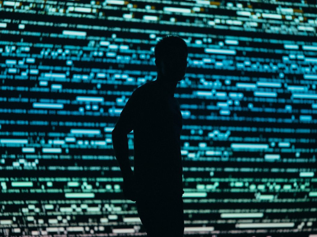 Silhouette on a digital background as security leaders face a new class of autonomous threat as Anthropic details the first cyber espionage campaign orchestrated by AI.