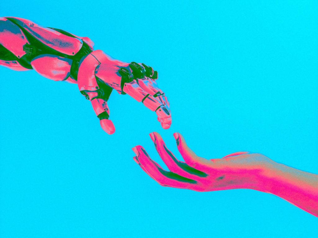 Robot reaching for a human hand as the world is in a race to deploy AI, but a leading voice in technology ethics warns prioritising speed over safety risks a "trust crisis," according to Suvianna Grecu, Founder of the AI for Change Foundation, argues that without immediate and strong governance, we are on a path to "automating harm at scale."